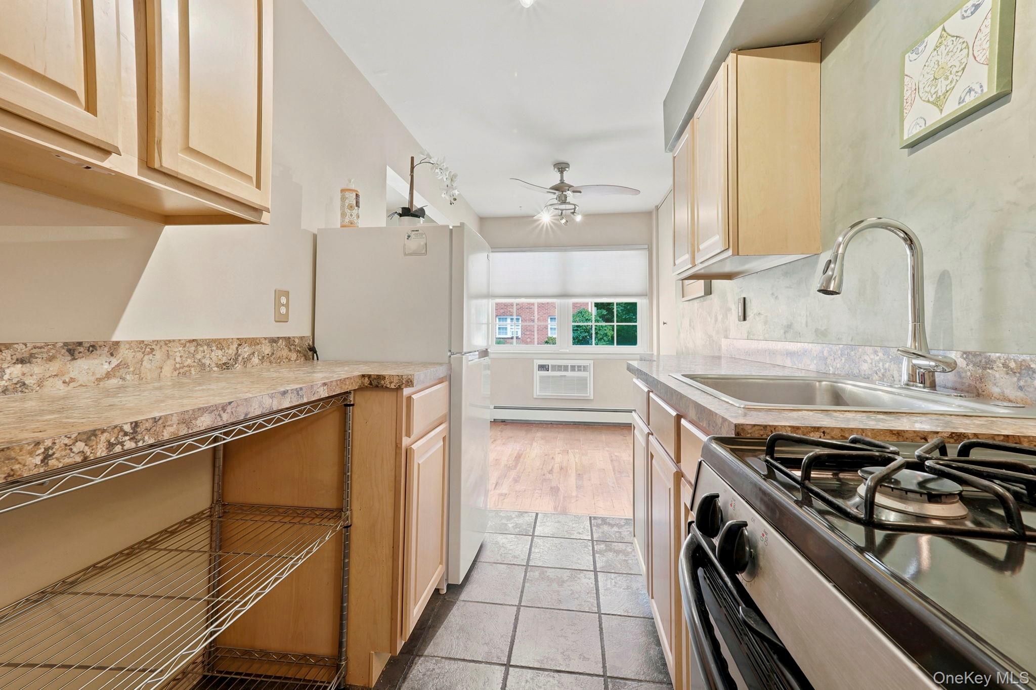 8 Colonial Road, Unit 36 Beacon, NY 12508 - Photo 11 of 20 This efficient galley style kitchen has additional open shelving to maximize every area of storage.
