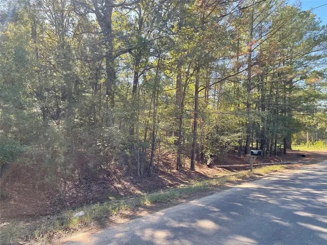 a view of yard with tree and wooden fence
