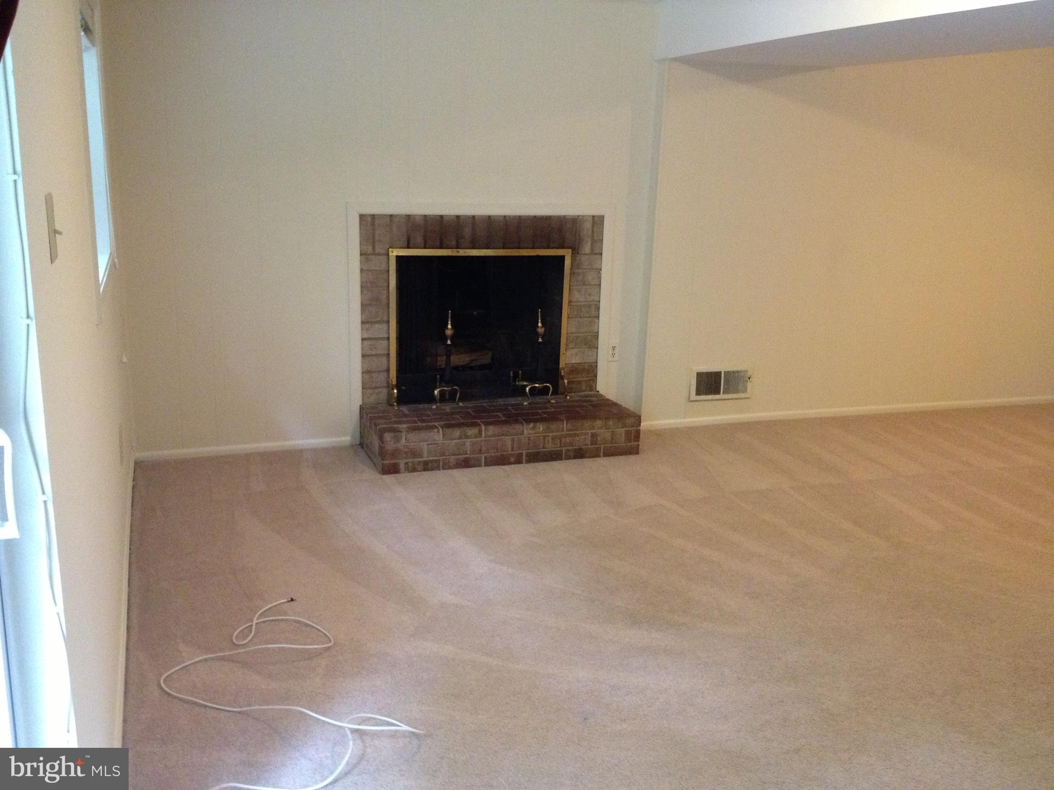 6803 Quebec Court Springfield, VA 22152 - Photo 16 of 17 fireplace in recreation room walks out to yard