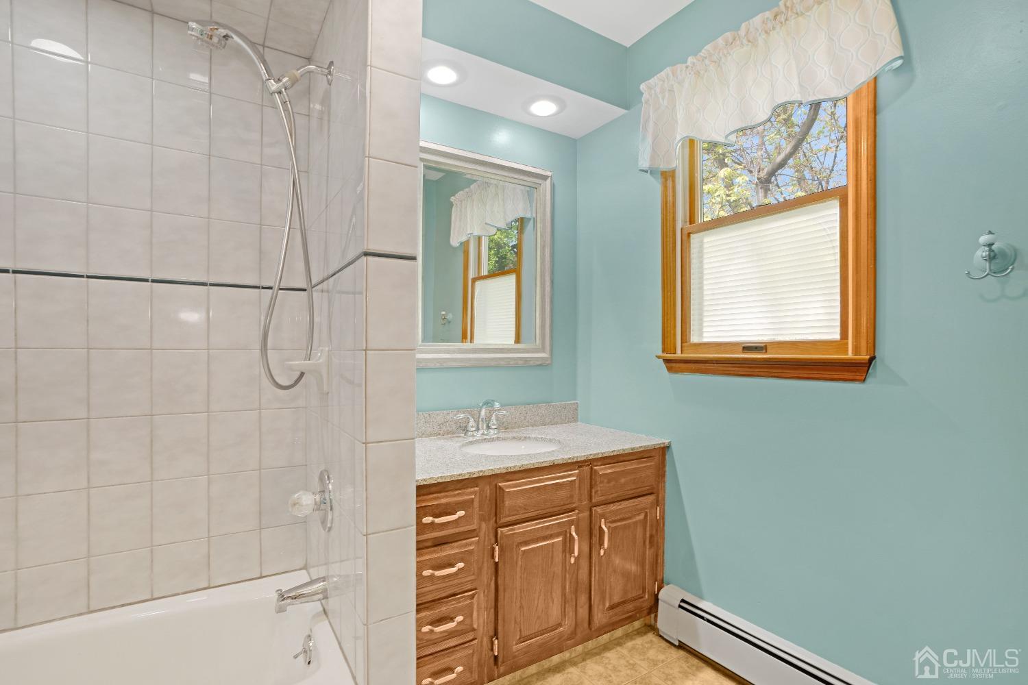44 Terry Avenue Edison, NJ 08820 - Photo 21 of 47 a bathroom with a sink a vanity and a mirror