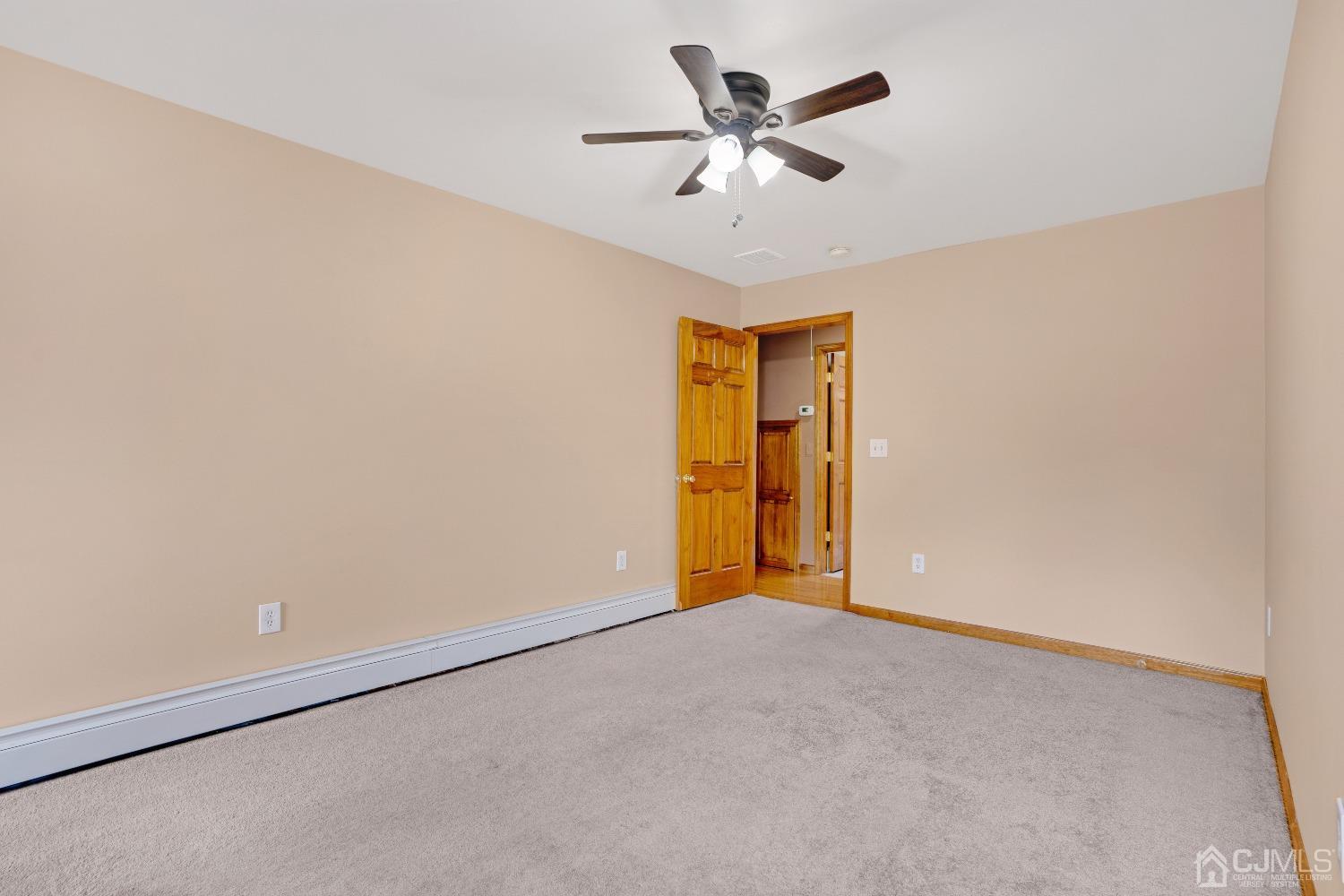 44 Terry Avenue Edison, NJ 08820 - Photo 25 of 47 an empty room with a ceiling fan and a window
