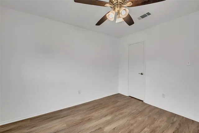 a view of an empty room and wooden floor