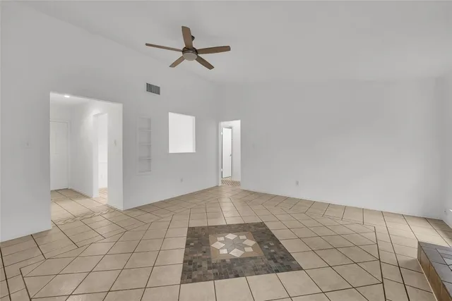 a view of a livingroom with a ceiling fan and window