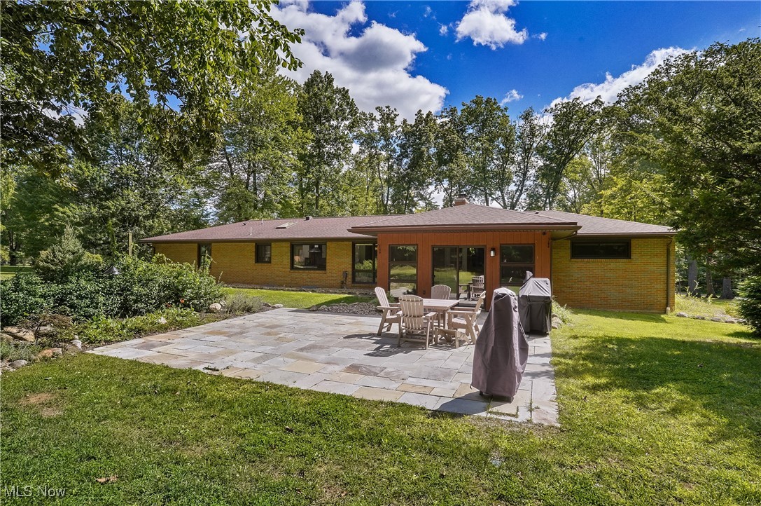 4555 Ranchwood Road Akron, OH 44333 - Photo 34 of 43 Back of house with a patio area, a yard, and brick siding