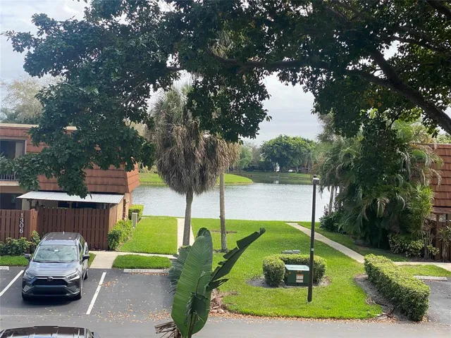 a car parked in front of a house and a yard