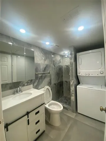 a bathroom with a double vanity sink toilet and a mirror