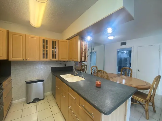 a kitchen with a sink cabinets and window