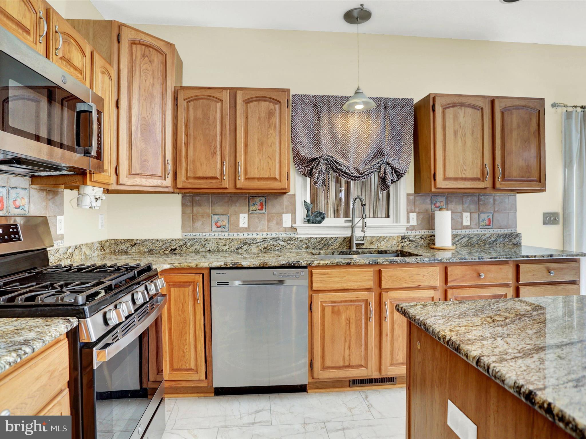23 Pin Oak Street Palmyra, PA 17078 - Photo 19 of 65 a kitchen with granite countertop a sink stove and cabinets