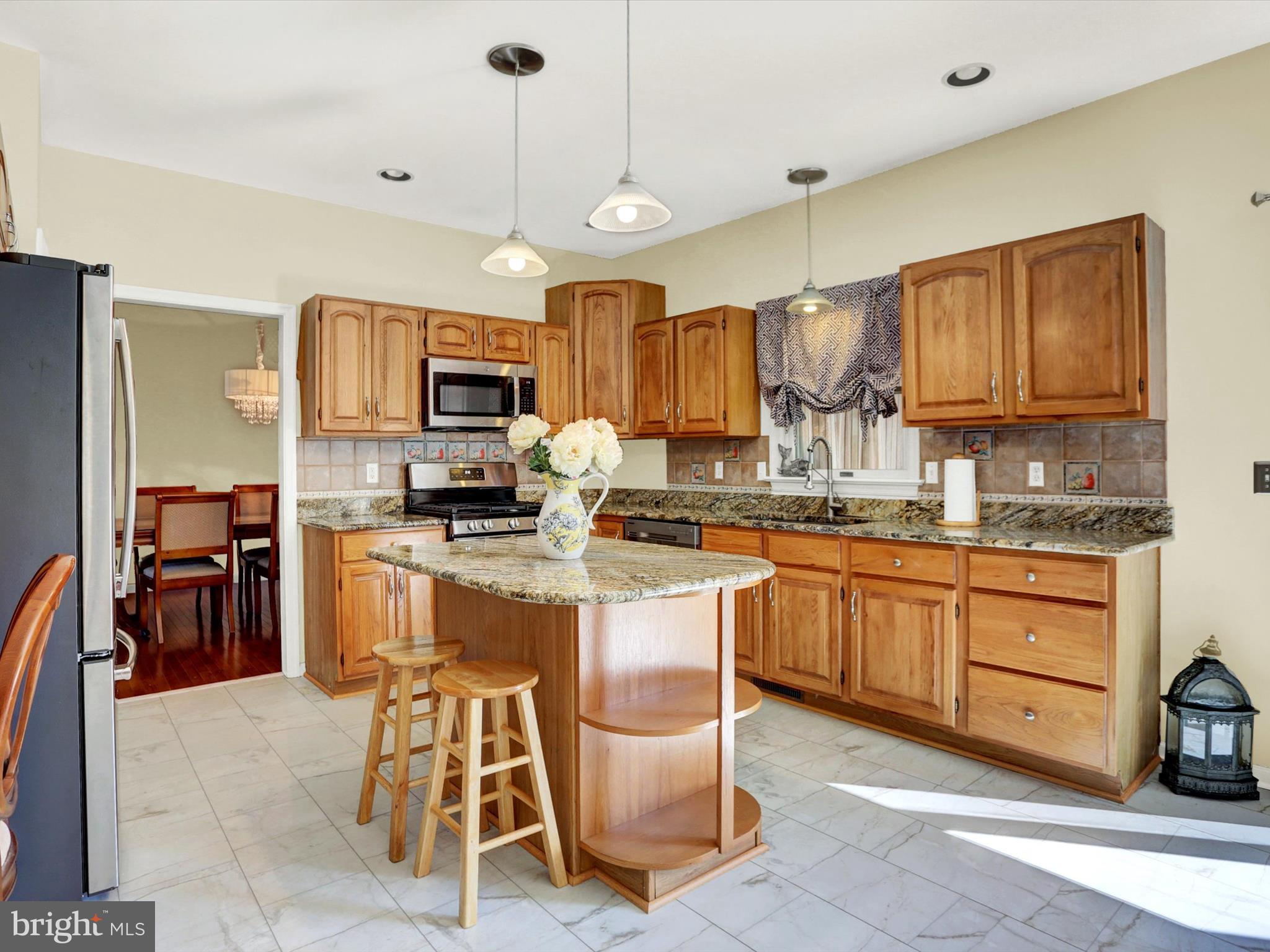 23 Pin Oak Street Palmyra, PA 17078 - Photo 21 of 65 a kitchen with stainless steel appliances granite countertop wooden cabinets a stove a sink and a microwave