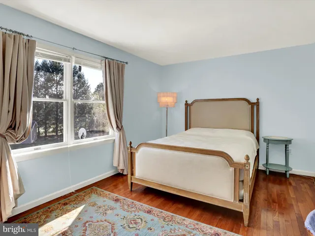 a bedroom with a bed and a mirror