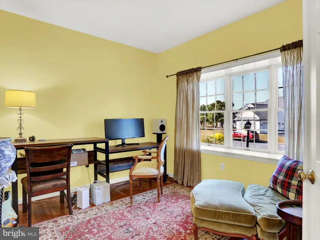 a living room with furniture a rug and a large window
