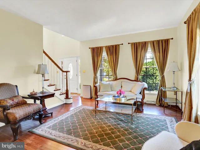 a living room with fireplace furniture and a rug