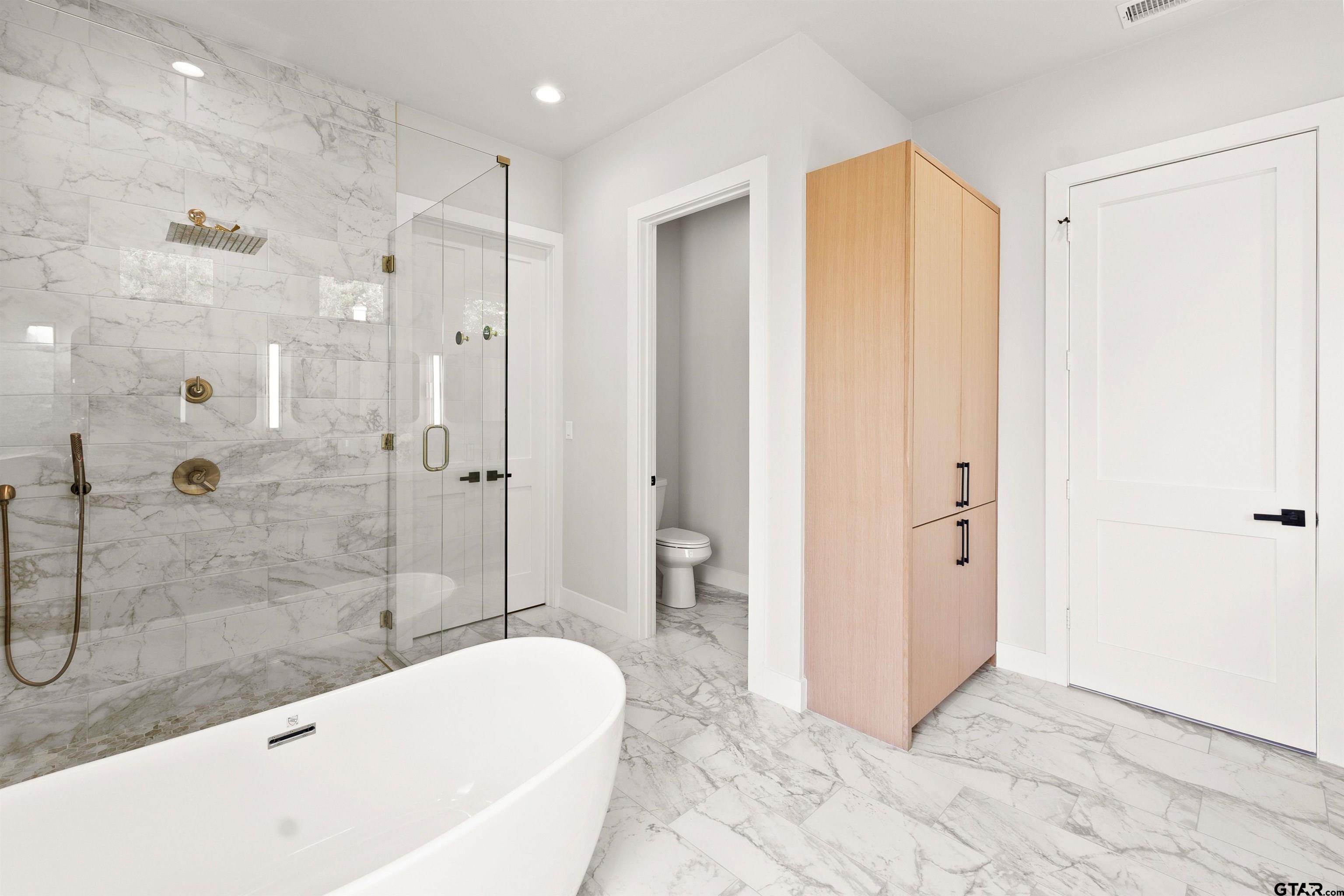 2895 Stewart Way Tyler, TX 75709 - Photo 21 of 44 a bathroom with a bathtub and a shower