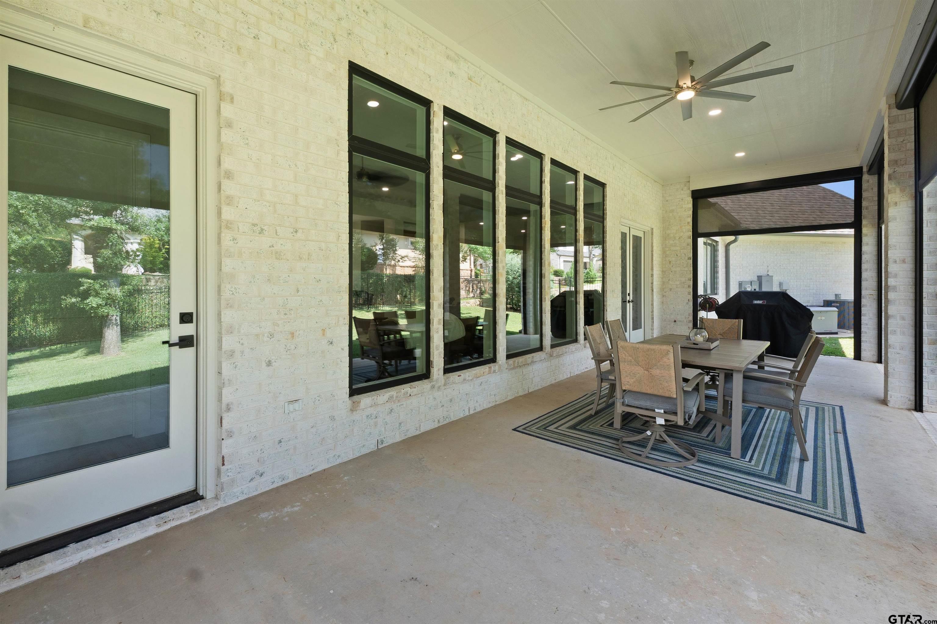 2895 Stewart Way Tyler, TX 75709 - Photo 26 of 44 a dining room with furniture a chandelier and fireplace