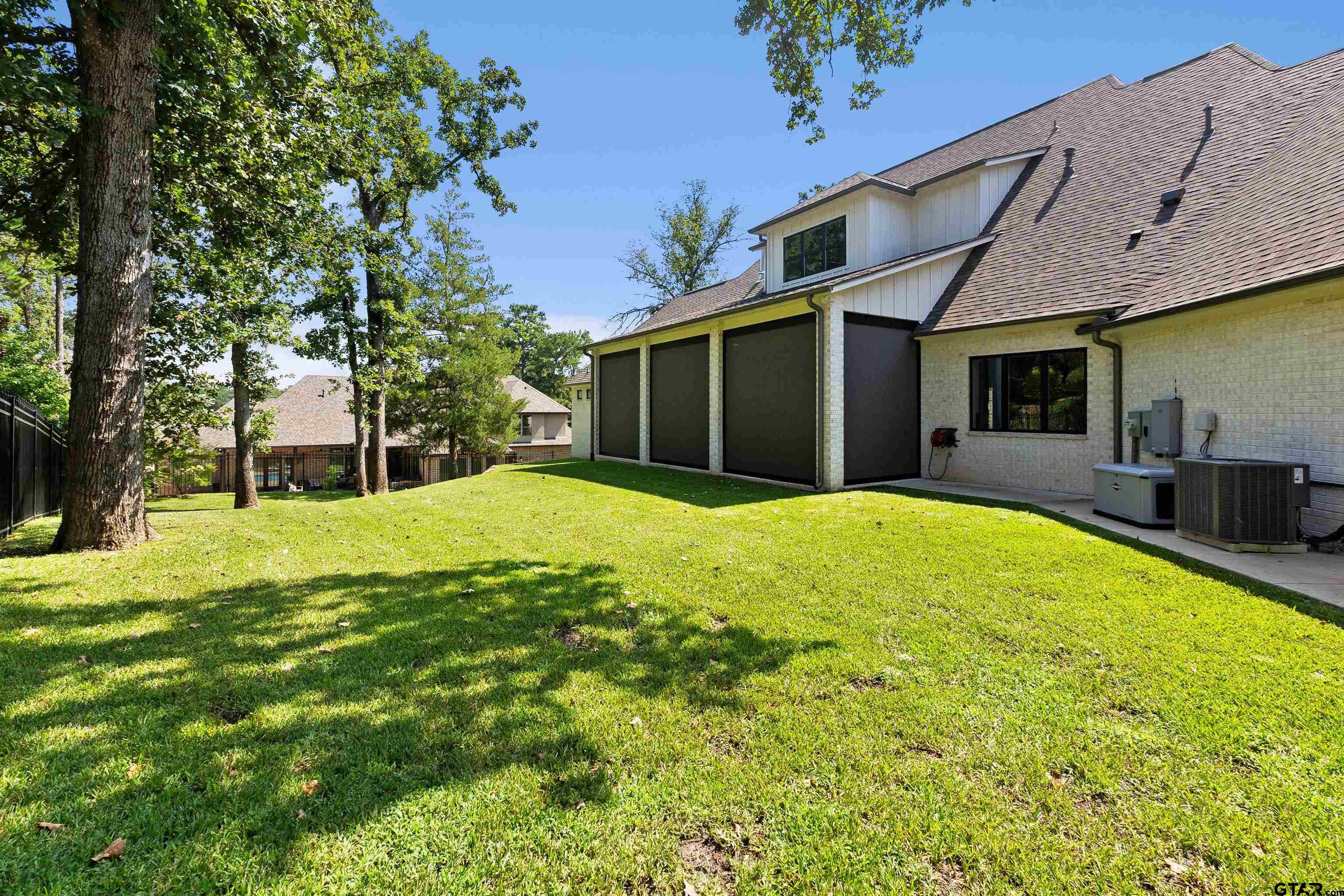 2895 Stewart Way Tyler, TX 75709 - Photo 30 of 44 a view of a house with a backyard and a tree
