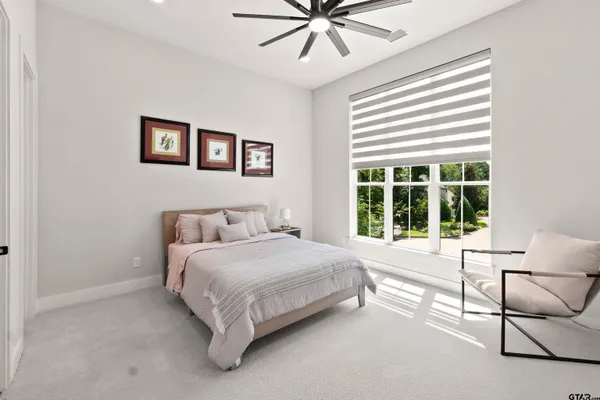 a bathroom with a toilet a sink a mirror and a shower