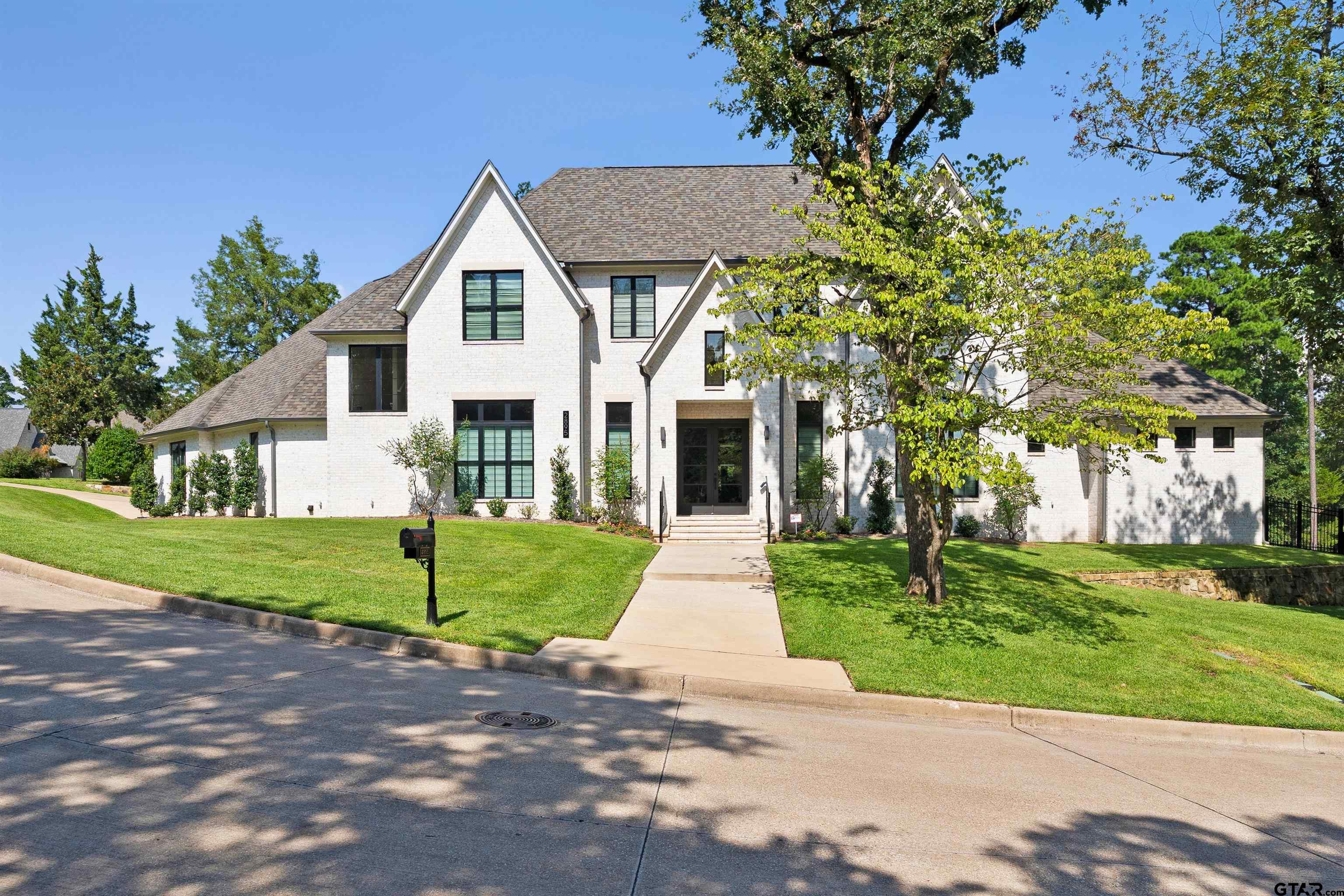 2895 Stewart Way Tyler, TX 75709 - Photo 31 of 44 a front view of a house with a yard and garage