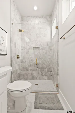 a bedroom with two beds and a large window