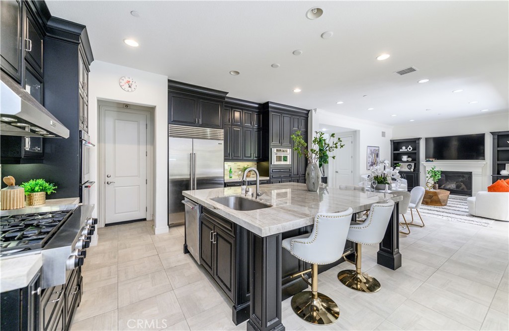 33 Swift Lake Forest, CA 92630 - Photo 13 of 56 a view of a kitchen with kitchen island stainless steel appliances a sink and living room view