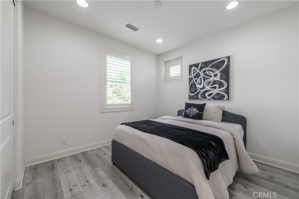 33 Swift Lake Forest, CA 92630 - Photo 28 of 56 a bedroom with a bed and a window