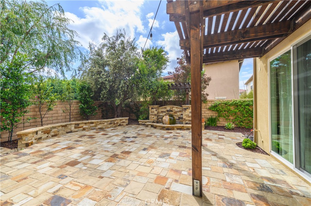 33 Swift Lake Forest, CA 92630 - Photo 37 of 56 a view of a backyard with floor to ceiling window potted plants and large tree