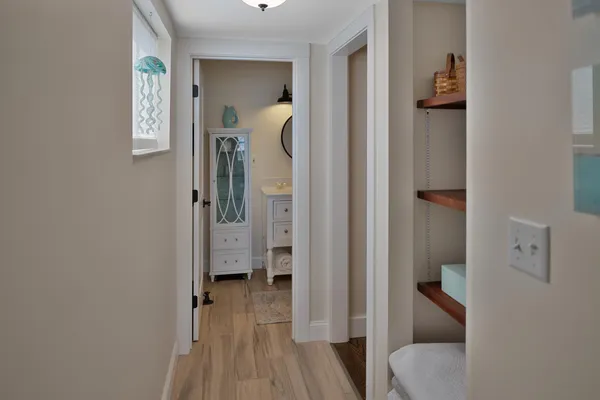 a view of hallway with wooden floor
