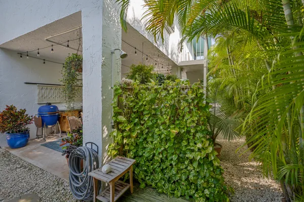 a view of a deck with table and chairs and potted plants