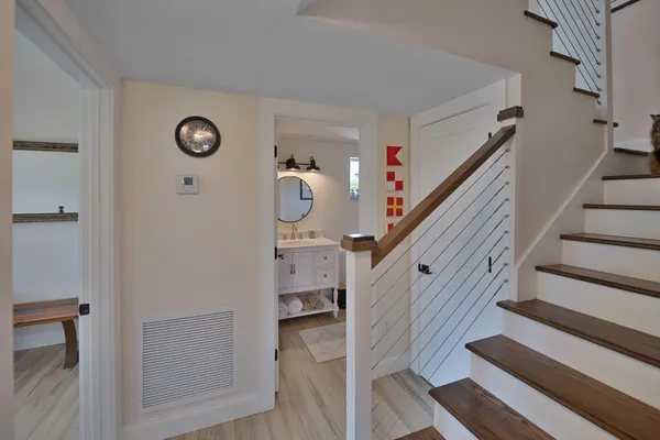 a view of entryway and hall with wooden floor