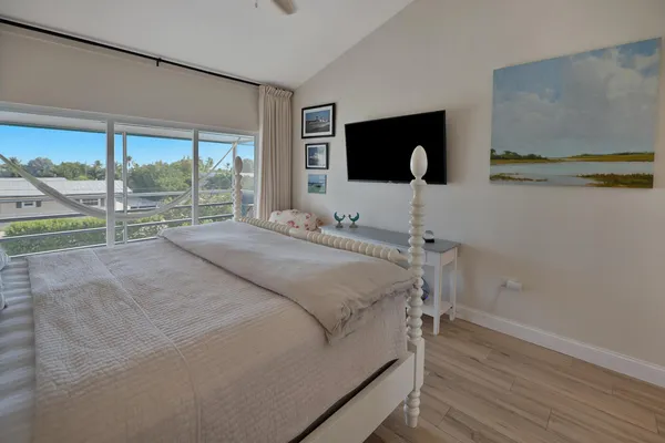 a bedroom with a bed and large window