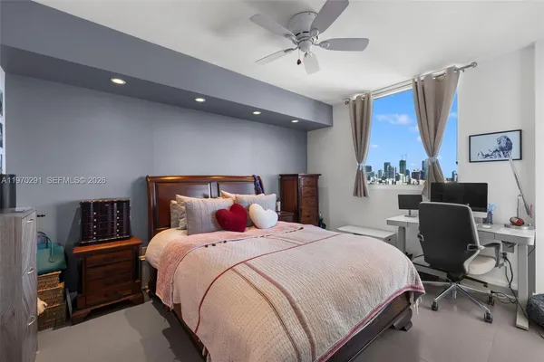 a bedroom with a bed and a television