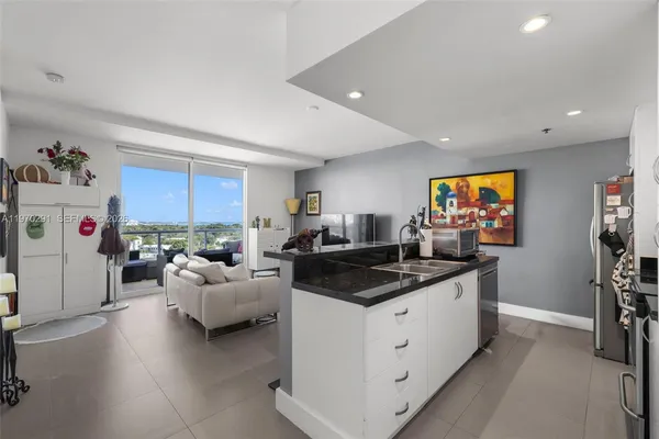 a living room with furniture a window and a flat screen tv