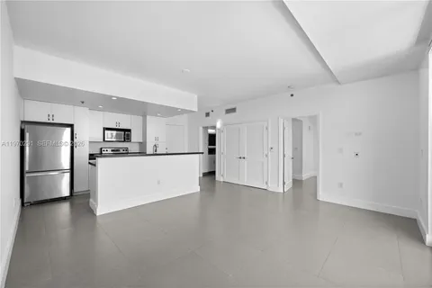 a view of kitchen with refrigerator stove microwave and cabinets