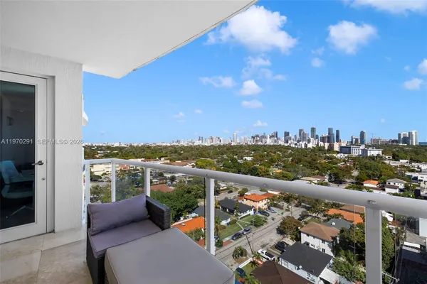 a living room with furniture and kitchen view