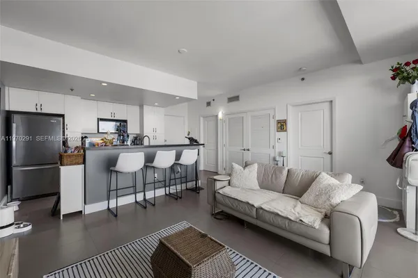 a view of a dining room with furniture and a kitchen