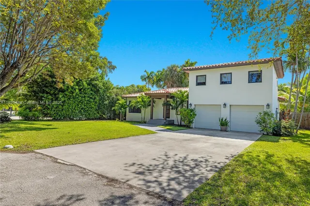 a view of a house with a yard and garage