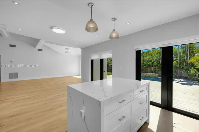 a kitchen with a stove and a large window