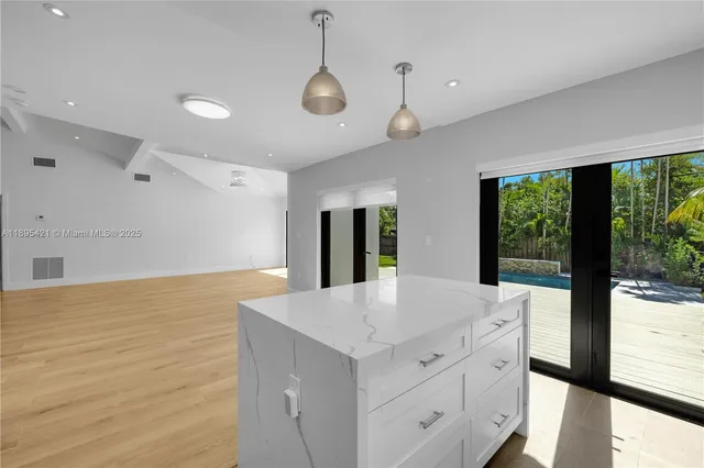 a kitchen with a stove and a large window