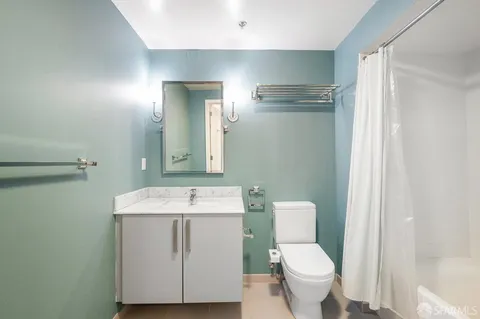 a bathroom with a toilet sink and mirror