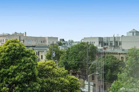 a view of a city with tall buildings and a big yard