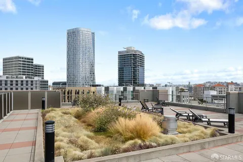 a view of swimming pool with outdoor seating and city view