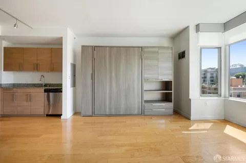 a view of kitchen with refrigerator and microwave