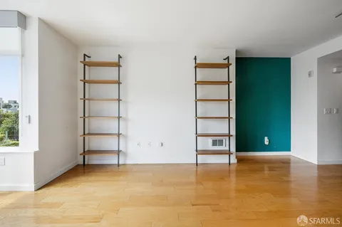 an empty room with closet and entryway