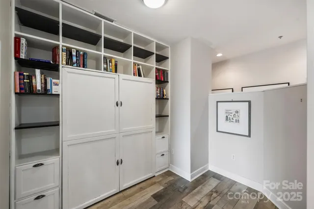 a view of a bedroom with cabinet and shelf