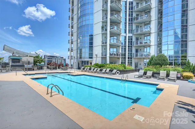 a view of a swimming pool with outdoor seating