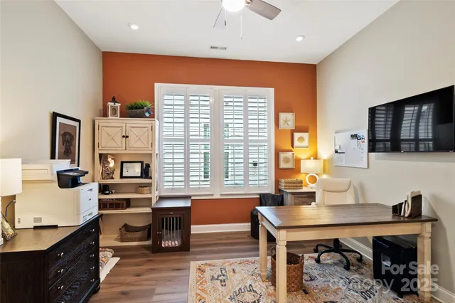 a workspace with furniture and large window