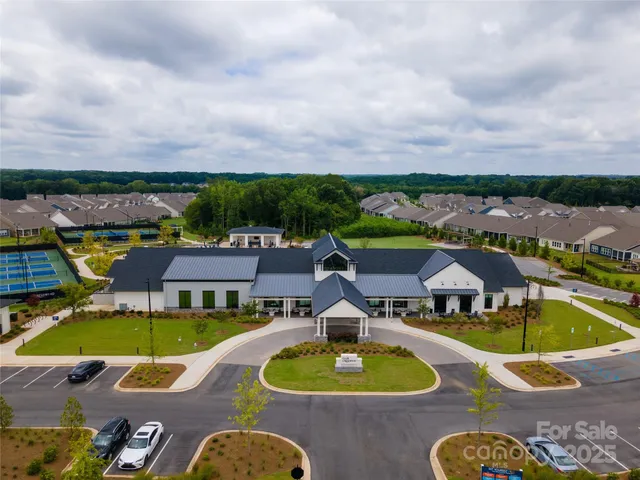 an aerial view of a house with swimming pool and mountains