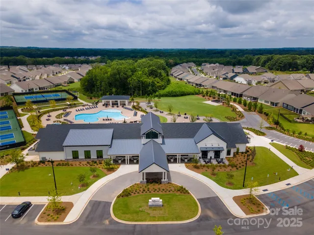 an aerial view of residential houses with outdoor space and swimming pool