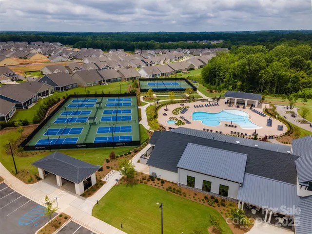 a aerial view of a house with swimming pool and ocean view