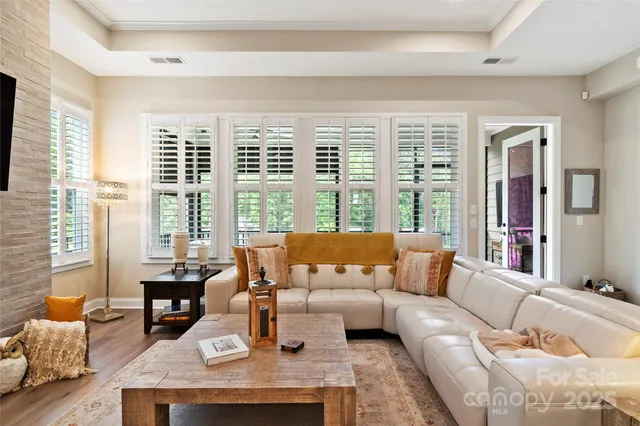 a living room with furniture and large windows