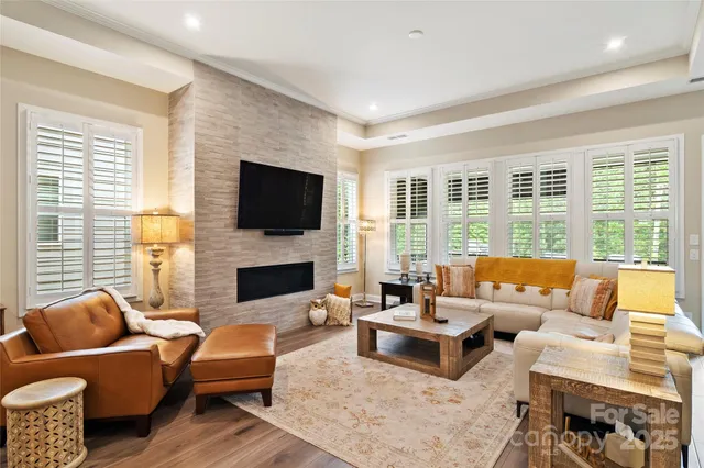 a living room with fireplace furniture and a flat screen tv